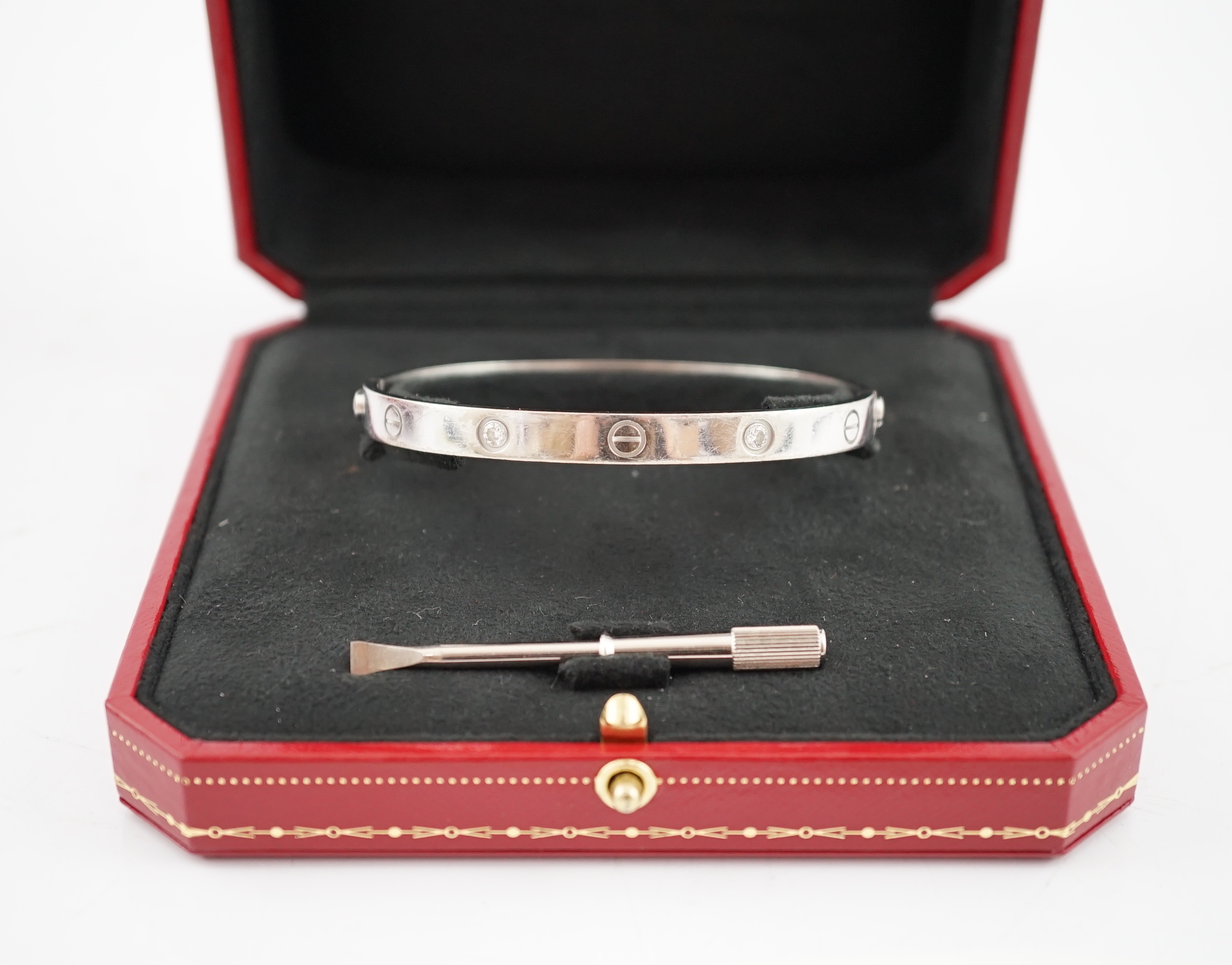 A modern Cartier 750 white gold and four stone gypsy set diamond 'Love' bangle